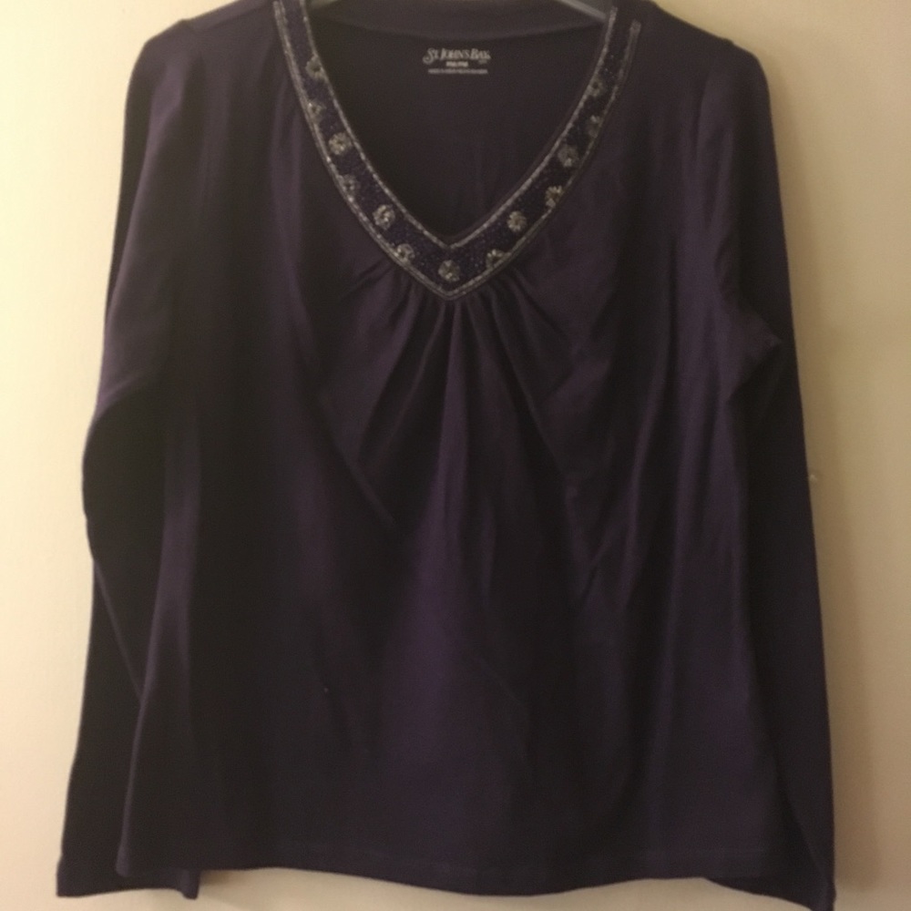 Long sleeved top with beaded neckline.